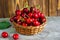 A basket with cherrys on wooden table