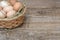 Basket with chicken eggs on a wooden background