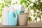 Basket with clean towels and detergents on table against blurred background