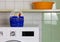 Basket for Clothespins on the Top of a Washing Machine in a Laundry Room