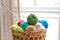 Basket with colorful knitting yarns and needles indoors, closeup