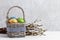 Basket of Easter eggs and bunch of catkins on the table