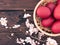 Basket with easter red eggs on rustic wooden table. Holiday back