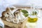 Basket with eryngii mushrooms, olive oil and ingredients for cooking on the wooden table of the kitchen background