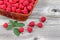 Basket Filled with Fresh Ripe Raspberries on Aged Wood