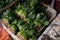 Basket filled with fresh spinach and carrots in a vibrant marketplace