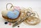 A basket filled with hearts sewn from scraps of fabric, next to large retro tailor`s scissors, coarse thread and colorful buttons