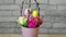 Basket with flowers, willow twigs and easter eggs in slowmo is spinning