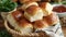 A basket of fluffy and buttery dinner rolls perfect for making mini sandwiches with the barbecue meats