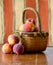 Basket of fresh peaches against a stripped background