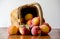 Basket of fresh peaches on white