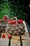 Basket of fresh strawberries on a background of a green garden and tree branches