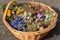 basket full of dried herbs and flowers, including cornflowers and chamomiles