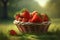basket full of fresh strawberries on green grass