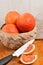 Basket of grapefruits and knife