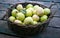 Basket of green apples on rustic porch