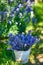 Basket with lavender bouquet on vintage chair, on lavender field background