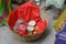 A basket loaded with turmeric, rice, floor, mustard oil. red cloth in indian marriage