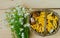 Basket of mushrooms and bouquet of camomiles