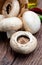 Basket of mushrooms champignon, cut feet, Agaricus Bisporus raw uncooked. With several ingredients.