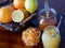 A basket of oranges and lemons,two opened jam jars and candied