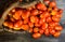 basket overflowing with pear tomatoes, from the organic garden on rustic wood