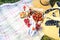 Basket, sandwiches, plaid and juice in a poppy field