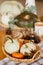 basket with small decorative white and orange pumpkins and cones.