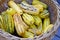 Basket of striped yellow and green delicata squash in the fall