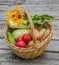 Basket with vegetables and a bouquet of yellow rudbeckia