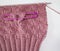 Basket weave pattern knitted on knitting needle in rose color wool. Stitch holder in place marking off extra stitches to be knit