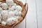 Basket of white dotted Easter eggs in brown wicker basket