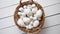 Basket of white dotted Easter eggs in brown wicker basket