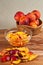 Basket of whole, organic, local peaches and a bowl of sliced peaches