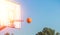basketball ball flies into the ring against a blue sky background. Basketball. Sport concept. Copy space on the right
