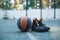 Basketball ball, sportive shoes for workout on basketball court, close up advertising photography in sunny day