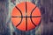 Basketball ball on wooden hardwood floor.