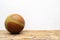 Basketball balls for sports and games are placed on a wooden table with white plaster