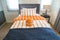 A basketball on the bed with bedside lamp in bedroom kids.