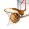 Basketball centering the basket, close up view.