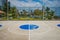 Basketball court center circle with park and skyline background