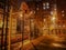 Basketball court with metal grille in yard at night in light of lights