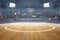 Basketball court with wooden floor, lights reflectors, and tribune