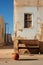 A basketball on an empty street, next to an old, dilapidated house in a poor area of ??the city, a slum.