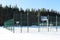 Basketball, football field deserted in winter in snow without people