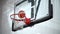 Basketball hits the basket by hitting the net in slow motion EDITORIAL