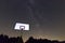 Basketball hoop and board under starry night. Milky way galaxy. Basketball court in night sky.