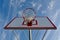 Basketball Hoop with Clouds and Blue Sky