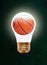 Basketball Inside Glowing Light Bulb Against Blackboard