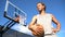 Basketball Man Holding Ball on Outside Basketball Court in City Park